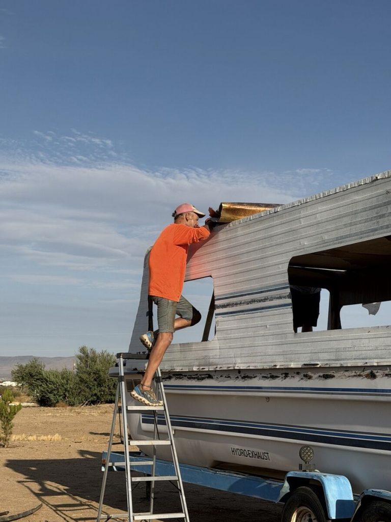 Worker removing the side of the old Yukon Delta cabin